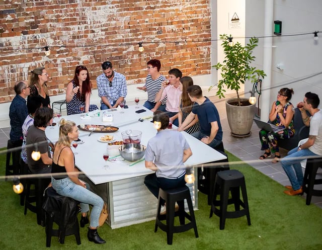 People gathered around large table outdoor living area at UKO Stanmore in Sydney Student Accommodation