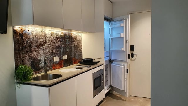 Small kitchen with fridge microwave and sink kitchen at UKO Surry Hills in Sydney Student Accommodation