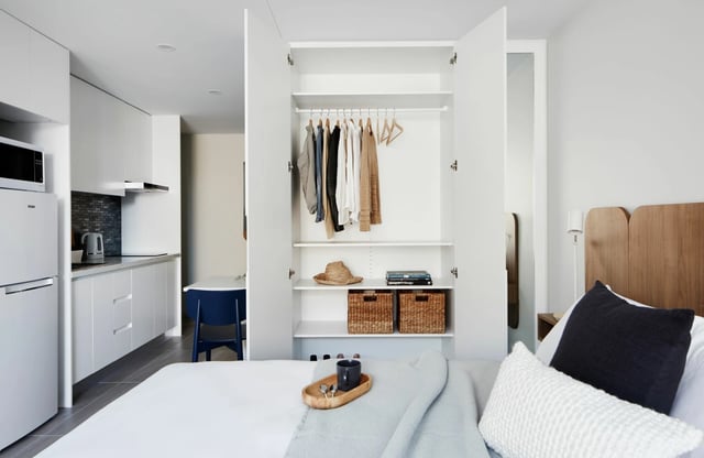 Wardrobe with clothes bed kitchen studio apartment at UKO West Ryde in Sydney Student Accommodation