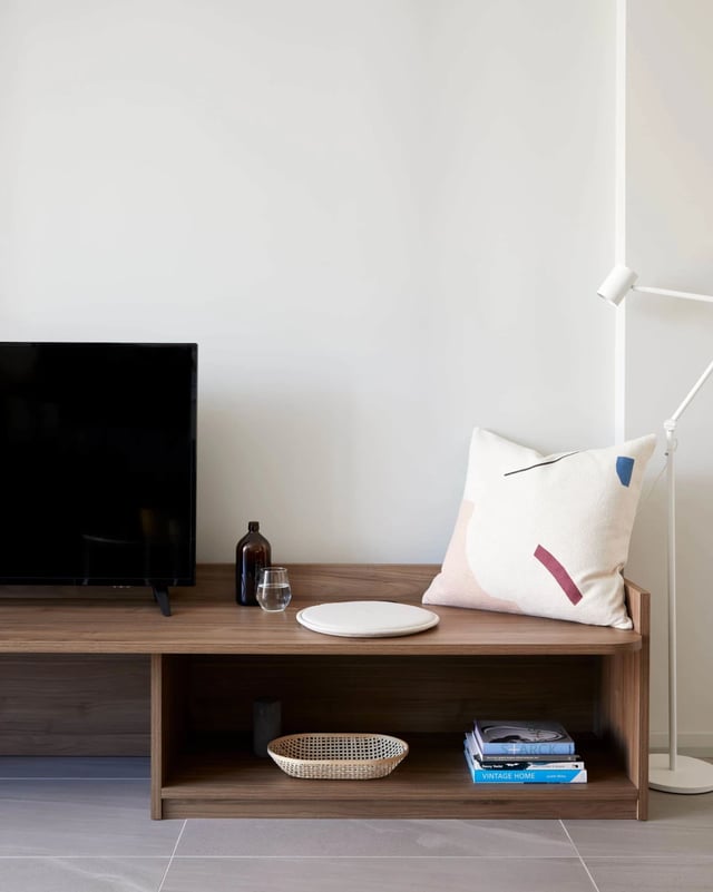 TV console with pillow books basket living room at UKO West Ryde in Sydney Student Accommodation