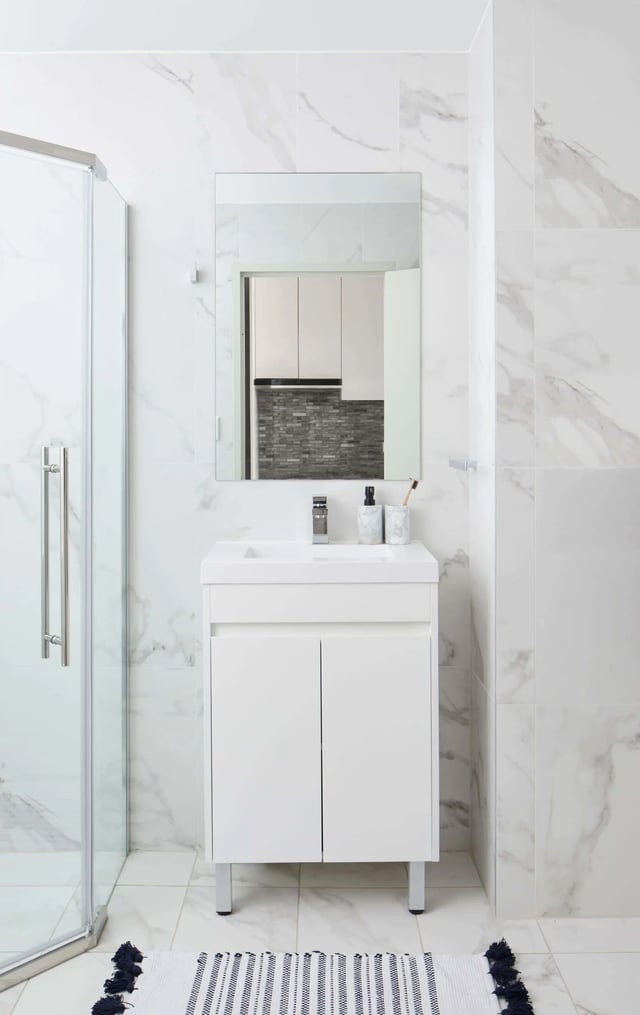 Modern white vanity sink glass shower and rug bathroom at UKO West Ryde in Sydney Student Accommodation