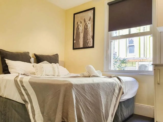 Bed with llamas art and towels bedroom at ume 142 Darlinghurst Village in Sydney Student Accommodation