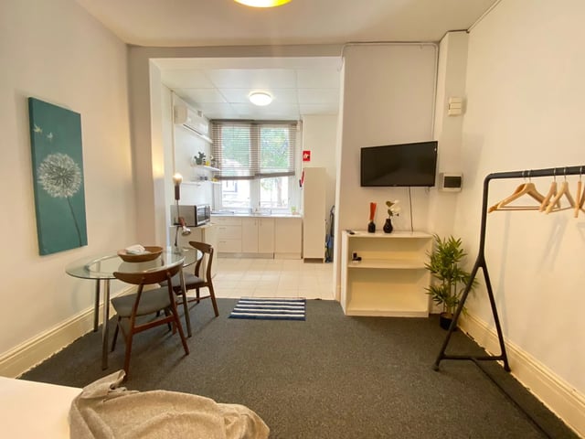 Dining area kitchen and TV studio apartment at ume 148 Darlinghurst Village in Sydney Student Accommodation