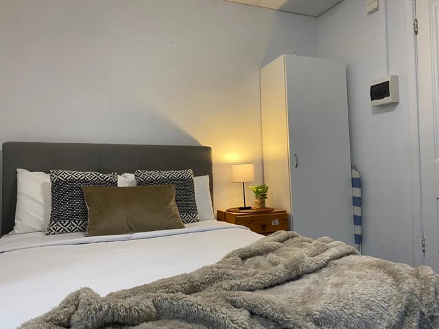 Bed with patterned pillows and fluffy throw bedroom at ume 148 Darlinghurst Village in Sydney Student Accommodation
