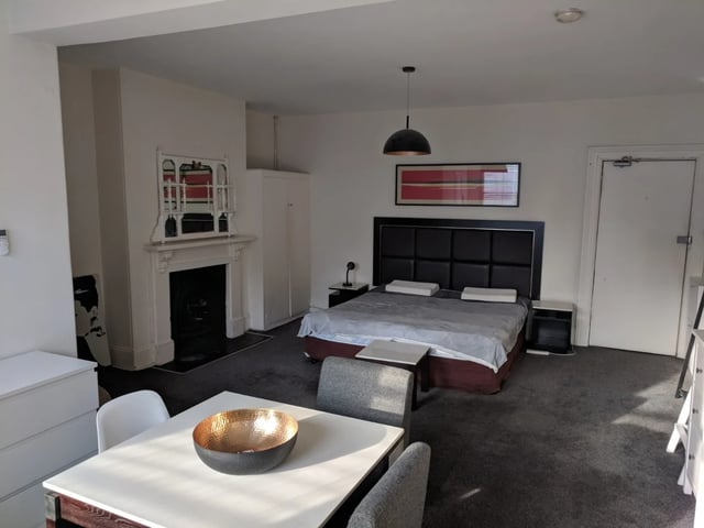 Bed fireplace and wardrobe bedroom at ume 148 Darlinghurst Village in Sydney Student Accommodation