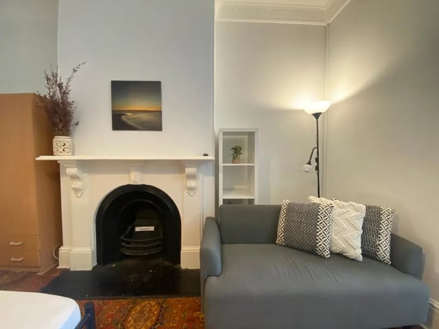 Fireplace couch painting and lamp living room at ume 150 Darlinghurst Village in Sydney Student Accommodation