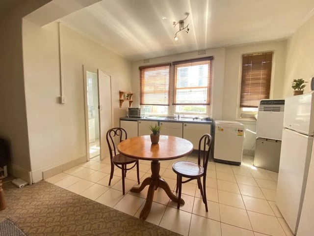 Round table chairs appliances and windows kitchen at ume 150 Darlinghurst Village in Sydney Student Accommodation