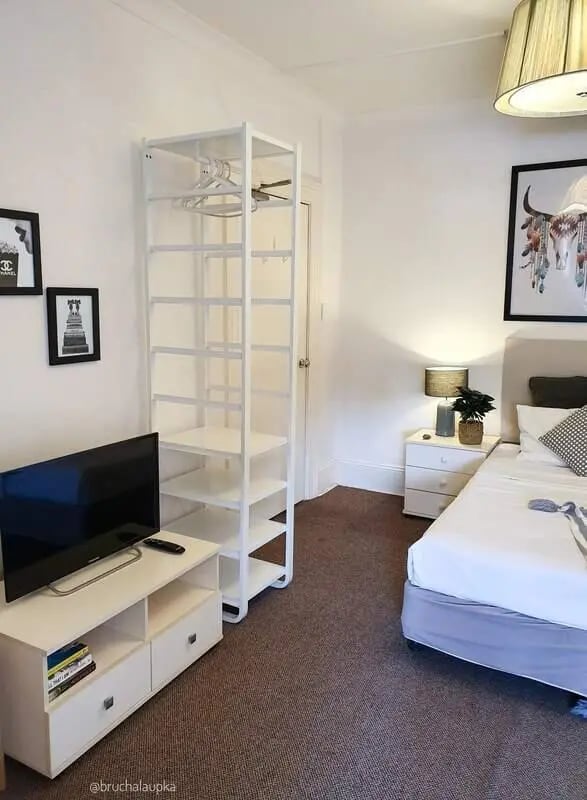 TV shelving unit bed bedside table bedroom at ume 152 Darlinghurst Village in Sydney Student Accommodation