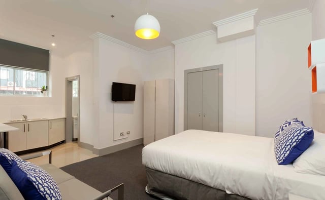 Bed sofa kitchen cabinets television wardrobe bedroom at ume Darlinghurst in Sydney Student Accommodation