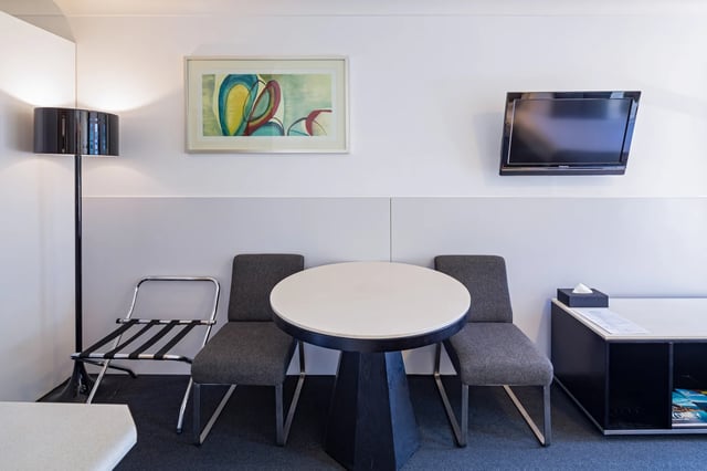 Artwork TV luggage rack table two chairs living room at ume Redfern Village in Sydney Student Accommodation