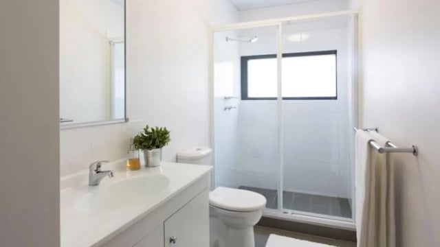 Sink toilet shower with plants and towels bathroom at Western Sydney University Campbelltown Village in Sydney Student Accommodation