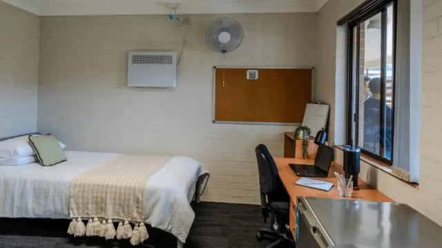 Bed desk fan and heater bedroom study area at Western Sydney University Hawkesbury Village in Sydney Student Accommodation