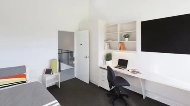 Bed desk chair shelves laptop and blackboard bedroom at Western Sydney University Hawkesbury Village in Sydney Student Accommodation