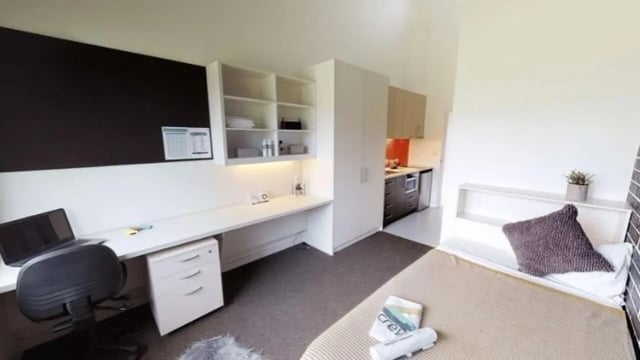 Desk laptop chair shelves kitchen cooking area bedroom. at Western Sydney University Hawkesbury Village in Sydney Student Accommodation
