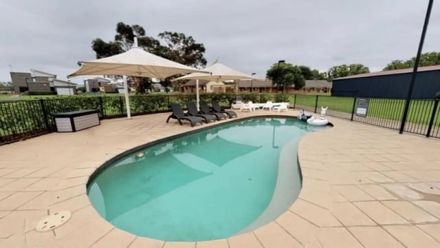 Pool with loungers and umbrellas playing area at Western Sydney University Hawkesbury Village in Sydney Student Accommodation