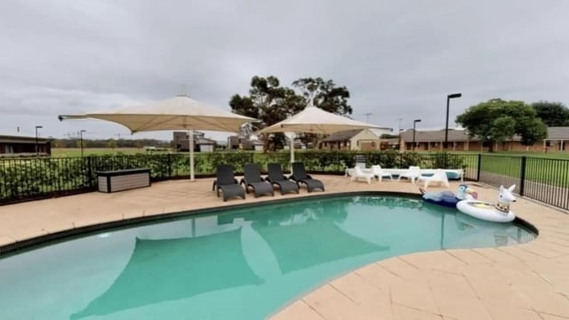 Pool loungers umbrellas inflatables and pool area at Western Sydney University Hawkesbury Village in Sydney Student Accommodation