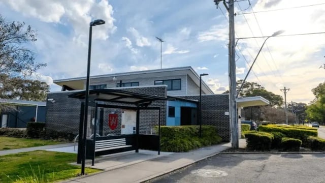 Brick building with bus stop and bench exterior at Western Sydney University Hawkesbury Village in Sydney Student Accommodation