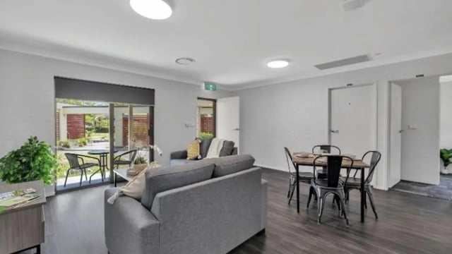 Sofa dining table chairs plant living room at Western Sydney University Hawkesbury Village in Sydney Student Accommodation