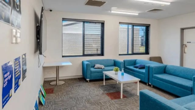 Blue sofas white coffee table television posters common area at Western Sydney University Hawkesbury Village in Sydney Student Accommodation