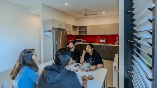 People eating at dining table kitchen area living room at Western Sydney University Hawkesbury Village in Sydney Student Accommodation