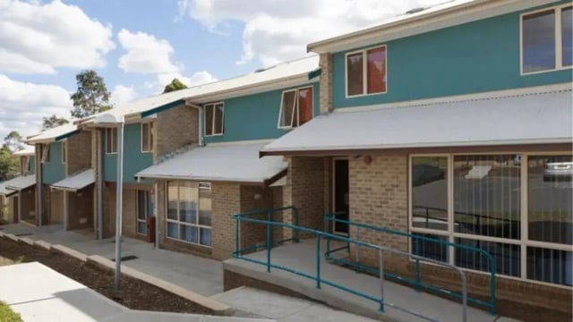 Brick buildings with turquoise siding and white roofs exterior at Western Sydney University Penrith Village in Sydney Student Accommodation