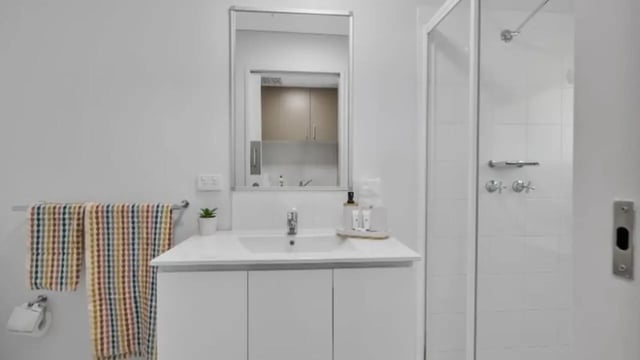 White vanity colorful towels shower stall bathroom at Western Sydney University Penrith Village in Sydney Student Accommodation