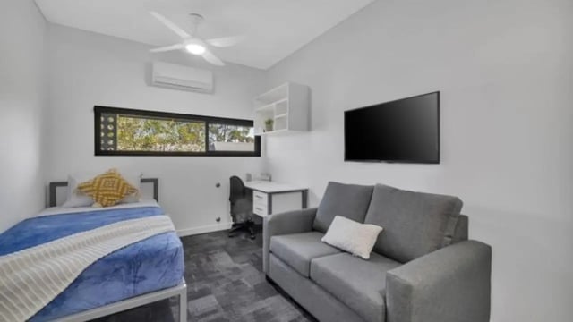 Bed desk sofa and TV living room at Western Sydney University Penrith Village in Sydney Student Accommodation