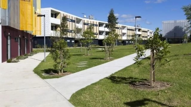 Modern building with walkway and trees exterior at Western Sydney University Penrith Village in Sydney Student Accommodation