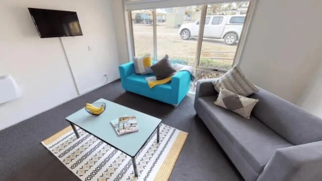 Two sofas coffee table TV living room at Western Sydney University Penrith Village in Sydney Student Accommodation