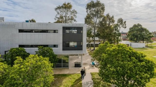 Modern building with trees pathway exterior at Western Sydney University Penrith Village in Sydney Student Accommodation