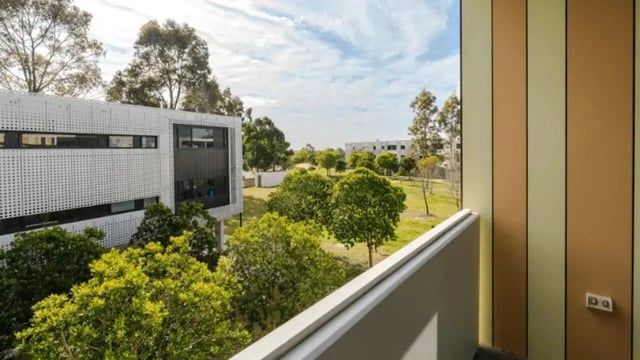 Balcony view of accommodation exterior with trees. at Western Sydney University Penrith Village in Sydney Student Accommodation