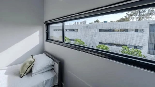 Bed with white sheets and pillows Bedroom at Western Sydney University Penrith Village in Sydney Student Accommodation