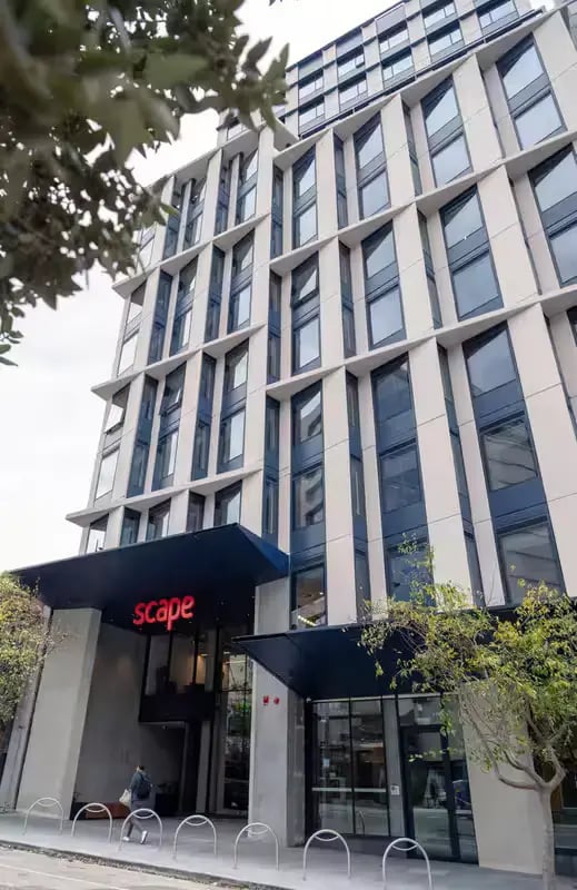 Scape building entrance with trees and bike racks exterior at Scape Leicester in Melbourne Student Accommodation