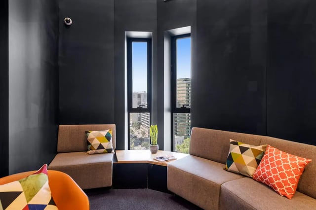 Modern seating area with city view living room at Scape Peel in Melbourne Student Accommodation