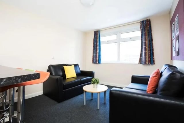 Two black sofas coffee table living room at St Martins House in Leicester Student Accommodation