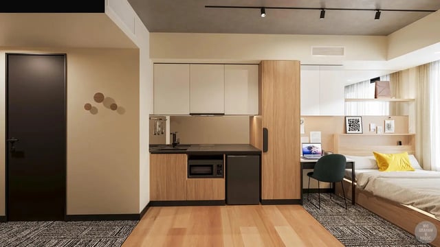 Kitchenette desk bed with yellow pillow bedroom at EPIISOD Macquarie Park in Sydney Student Accommodation