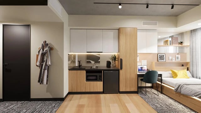 Studio apartment with bed desk kitchen and door at EPIISOD Macquarie Park in Sydney Student Accommodation