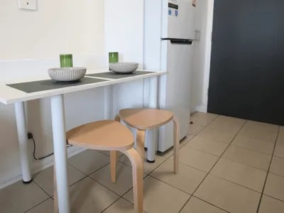 Table with bowls and stools kitchen area at Student Living - Shafston in Brisbane Student Accommodation