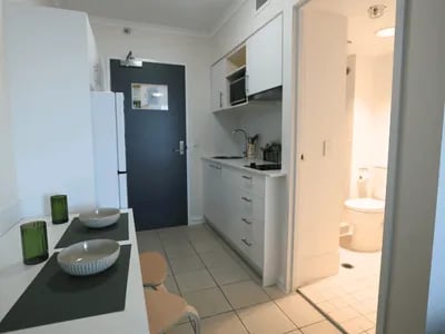 Dining table microwave kitchen and bathroom studio apartment at Student Living - Shafston in Brisbane Student Accommodation