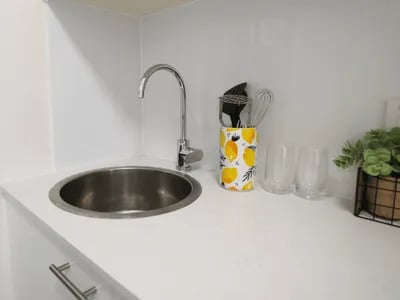 Sink faucet utensil holder glasses plant kitchen at Student Living - Shafston in Brisbane Student Accommodation