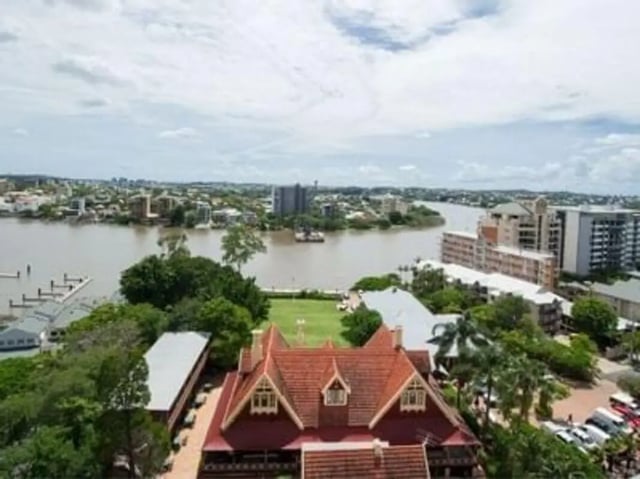 Red tiled building with river and city skyline Exterior at Student Living - Shafston in Brisbane Student Accommodation