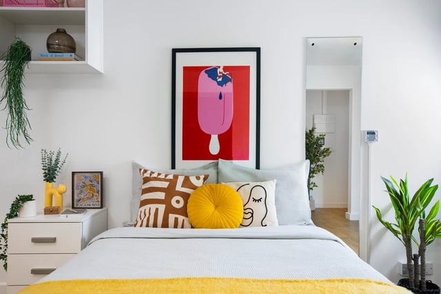 Bed pillows artwork and plant Bedroom at Piccadilly Court in London Student Accommodation
