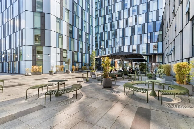 Outdoor seating area with modern benches and tables exterior at Chapter Kings Cross in London Student Accommodation