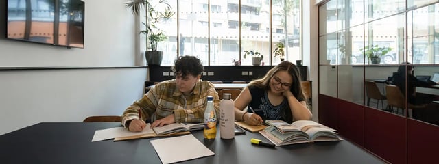 Two students studying at a table with books study area at The Valentine London in London Student Accommodation