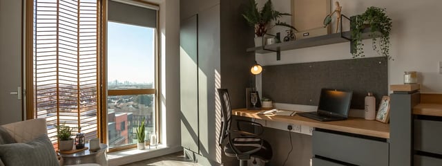 Desk with laptop chair and window view study area at The Valentine London in London Student Accommodation