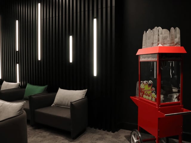 Modern lounge with chairs and popcorn machine lounge area at Spring Mews in London Student Accommodation