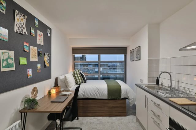 Bed desk kitchen area with sink at AXO Camden in London Student Accommodation