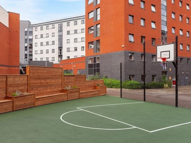 Basketball court with wooden benches student accommodation exterior at The Forge in Sheffield Student Accommodation