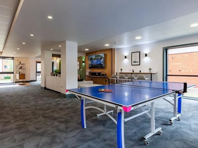Ping pong table with paddles and rackets recreation area at The Forge in Sheffield Student Accommodation