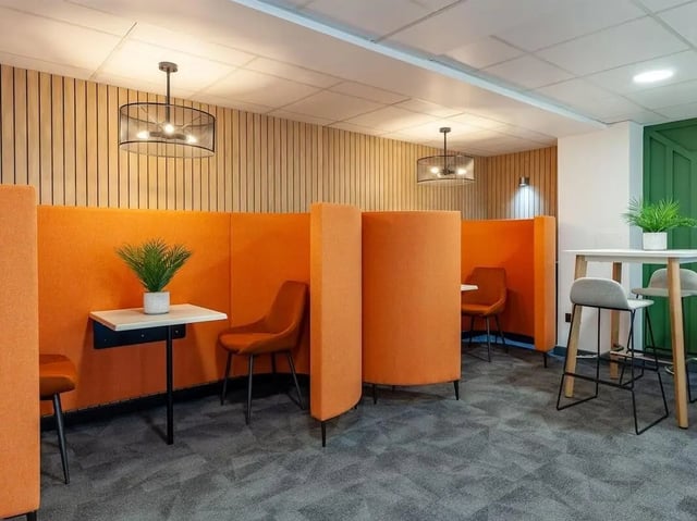 Orange booths chairs tables plants study area at The Forge in Sheffield Student Accommodation